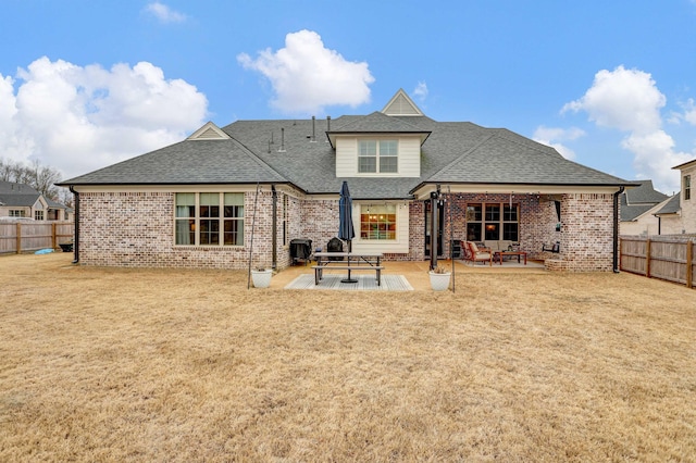 back of property featuring a lawn and a patio