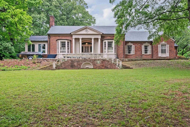 greek revival inspired property with a front yard