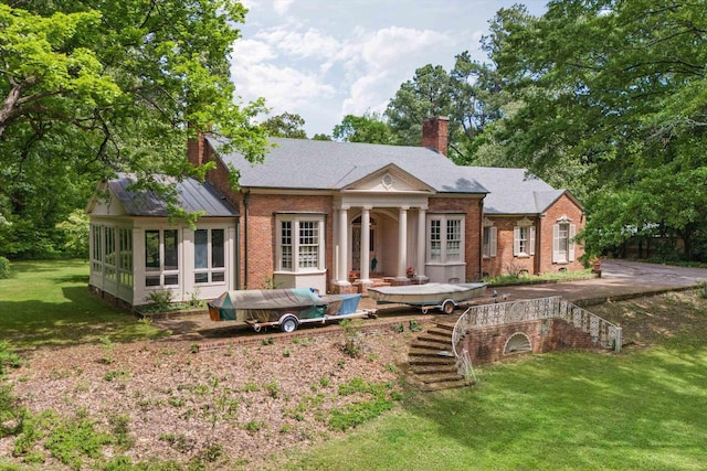 rear view of house with a lawn and french doors