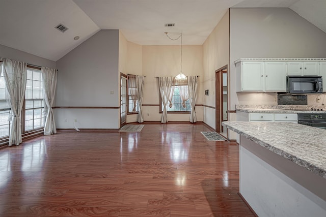 kitchen with pendant lighting, black appliances, dark hardwood / wood-style floors, tasteful backsplash, and white cabinetry