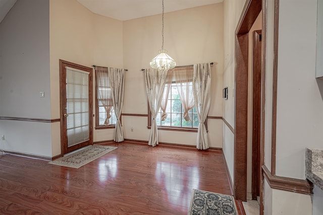 foyer featuring hardwood / wood-style flooring and a notable chandelier