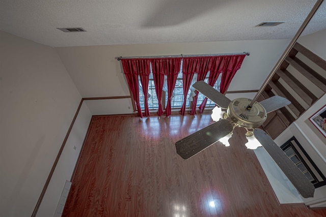 details featuring ceiling fan, a textured ceiling, and hardwood / wood-style flooring