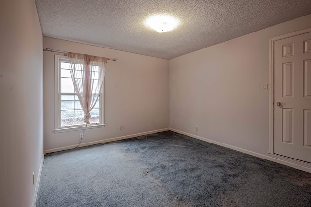 carpeted spare room featuring a textured ceiling