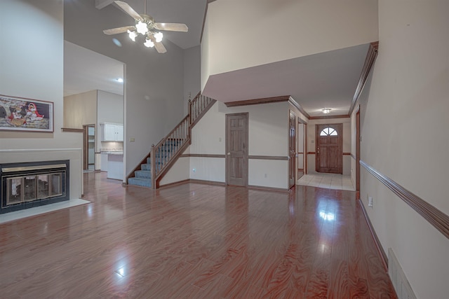 unfurnished living room with ceiling fan and light hardwood / wood-style floors