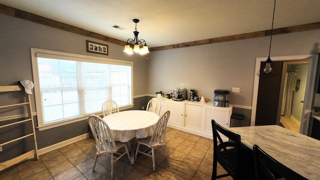 tiled dining space with an inviting chandelier