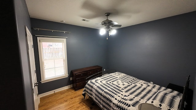 bedroom featuring light hardwood / wood-style flooring and ceiling fan