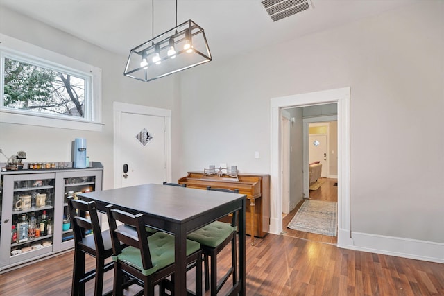 dining space with dark wood-type flooring