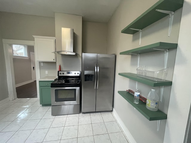 kitchen featuring open shelves, wall chimney exhaust hood, baseboards, and stainless steel appliances