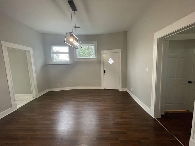 interior space with wood finished floors, visible vents, and baseboards