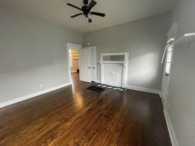 unfurnished living room featuring ceiling fan, wood finished floors, and baseboards