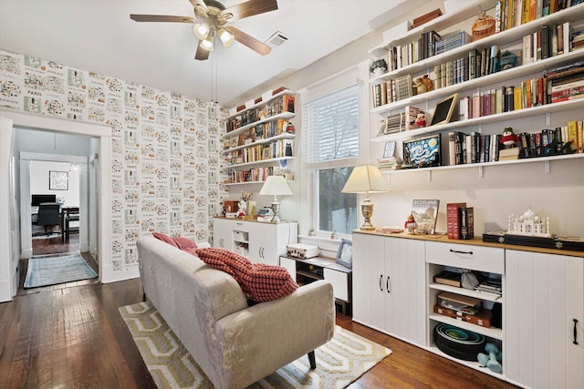 living area with ceiling fan and dark wood-type flooring