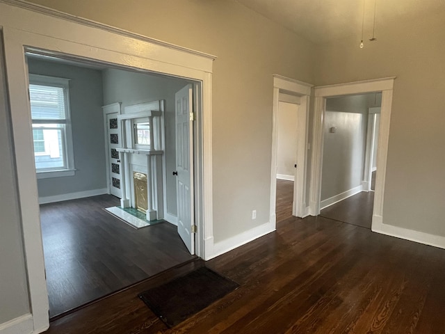 hall with dark wood-style floors and baseboards