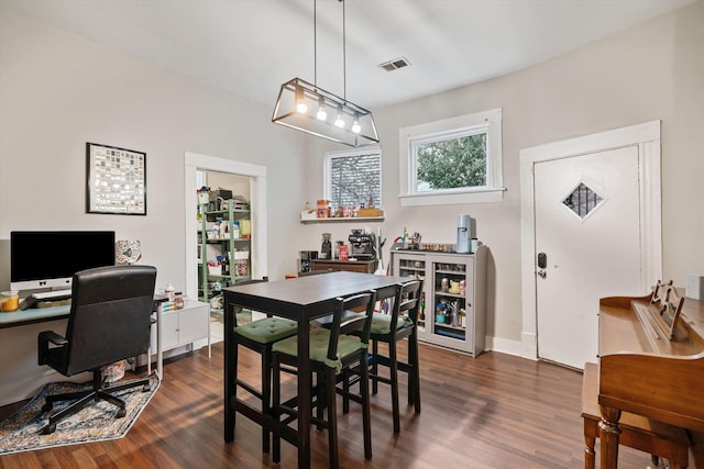 dining space with dark wood-type flooring