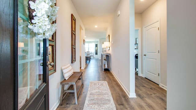 hallway with baseboards and wood finished floors