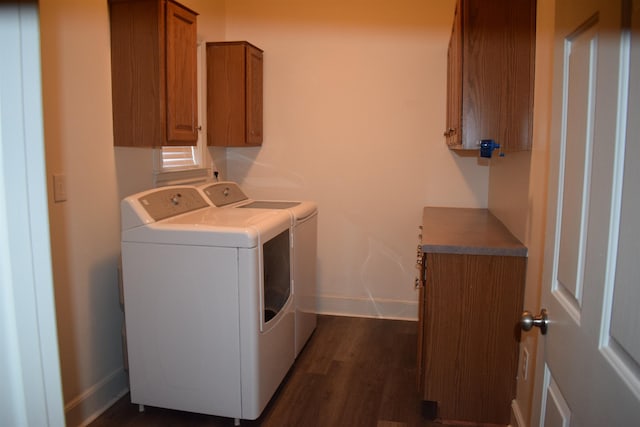 washroom with cabinets, independent washer and dryer, and dark wood-type flooring