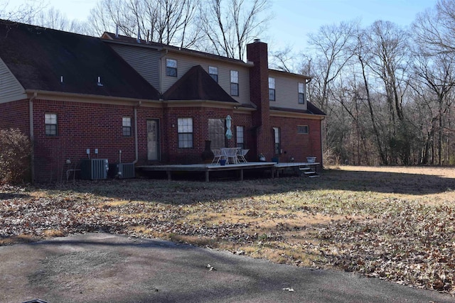 back of property featuring cooling unit and a wooden deck