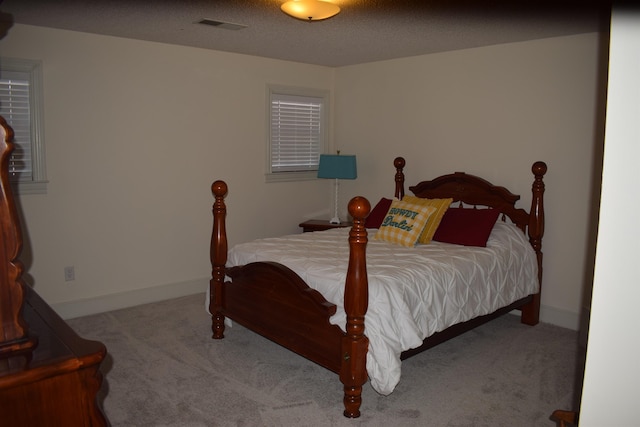 carpeted bedroom featuring a textured ceiling