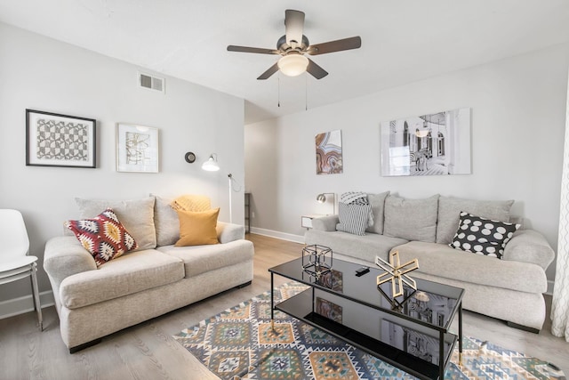 living room featuring ceiling fan and light wood-type flooring