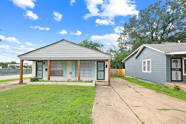 view of front of property with covered porch and a front yard