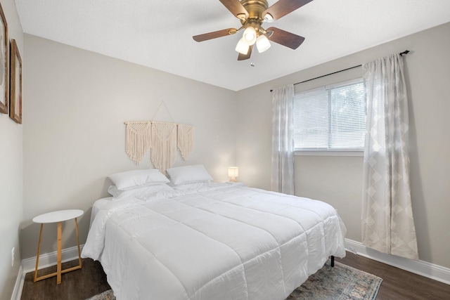 bedroom with ceiling fan and dark wood-type flooring