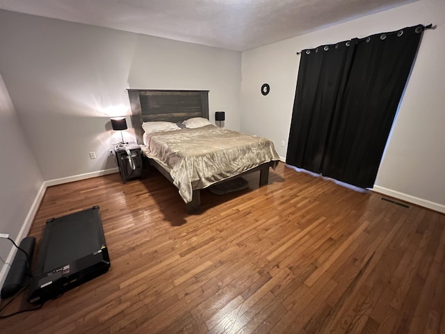 bedroom with hardwood / wood-style flooring