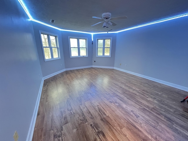 unfurnished room featuring hardwood / wood-style flooring, ceiling fan, and crown molding