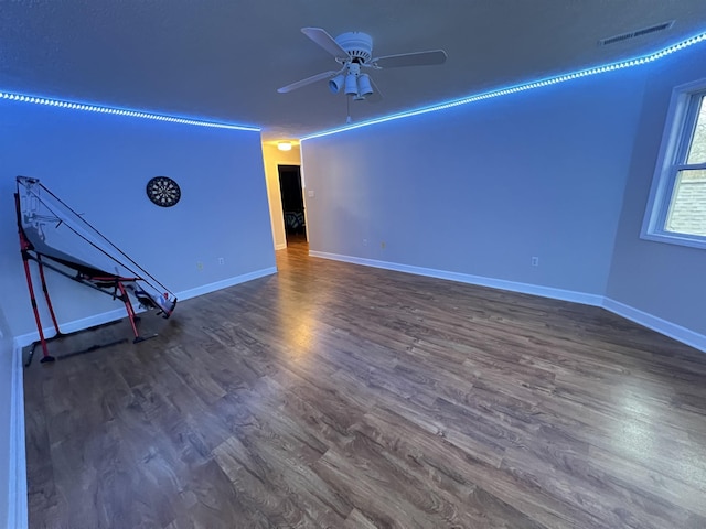 unfurnished room featuring ceiling fan and dark hardwood / wood-style flooring