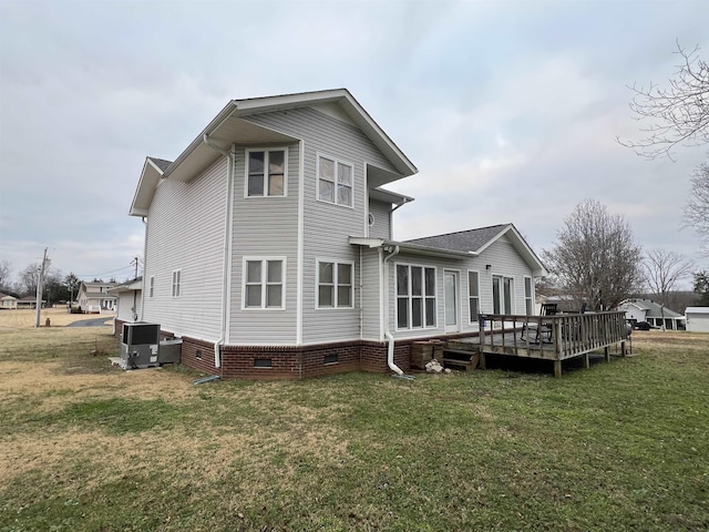 back of house with a yard, a deck, and central AC unit