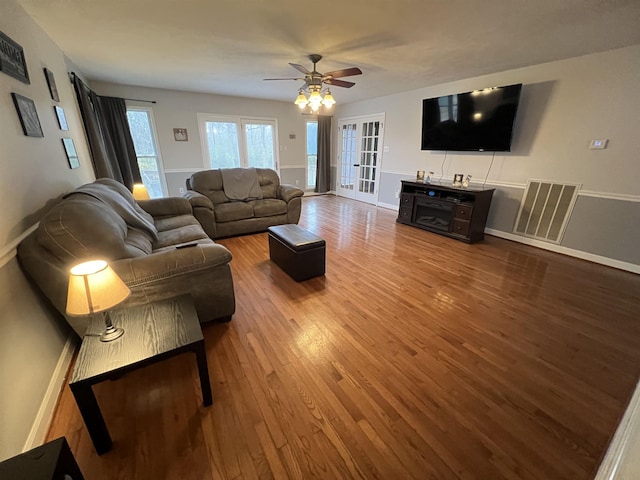 living room with ceiling fan and hardwood / wood-style floors