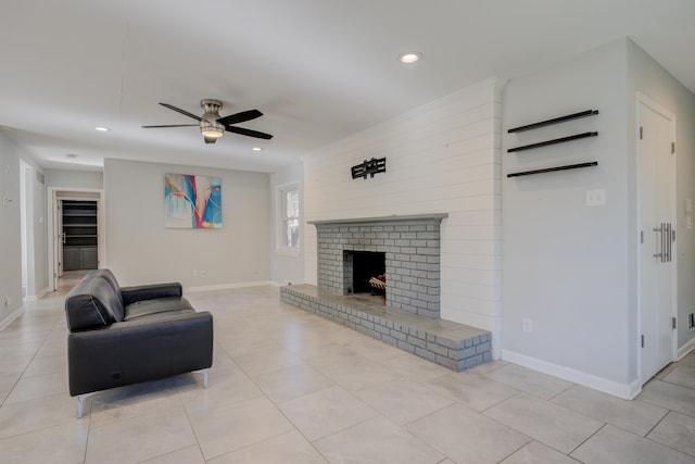 living room with ceiling fan, light tile patterned floors, and a brick fireplace