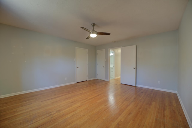 empty room with ceiling fan and light hardwood / wood-style flooring