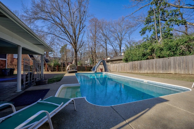 view of pool featuring a patio area and a water slide