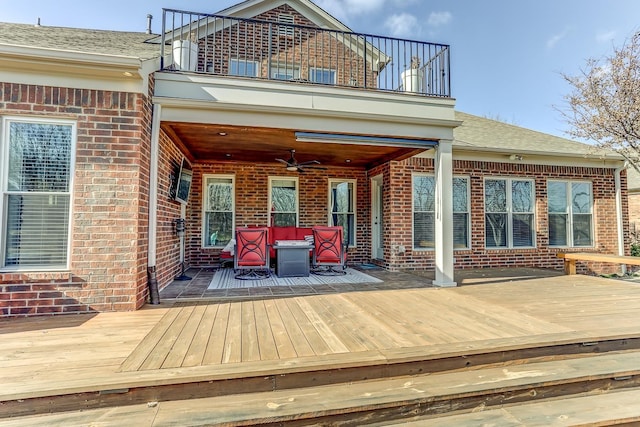 wooden deck featuring ceiling fan