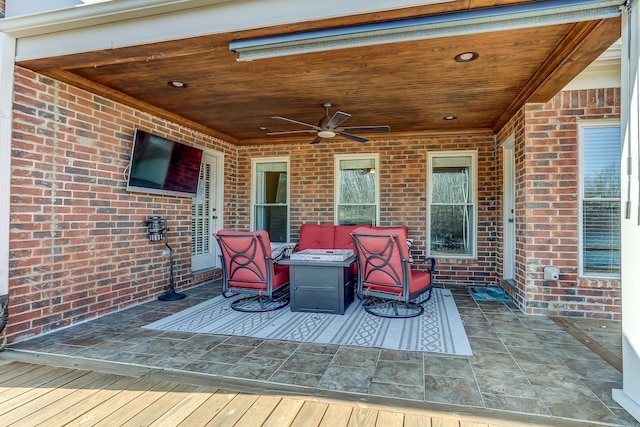 deck featuring ceiling fan and a patio