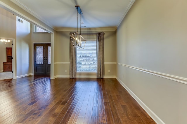 unfurnished dining area with french doors, crown molding, dark hardwood / wood-style floors, and a notable chandelier