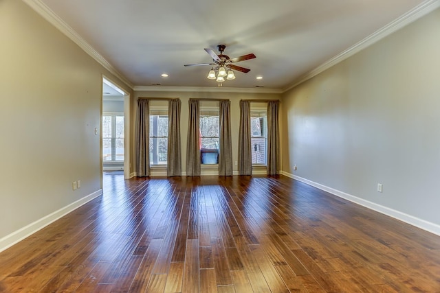 unfurnished room featuring ceiling fan, dark wood-type flooring, plenty of natural light, and ornamental molding