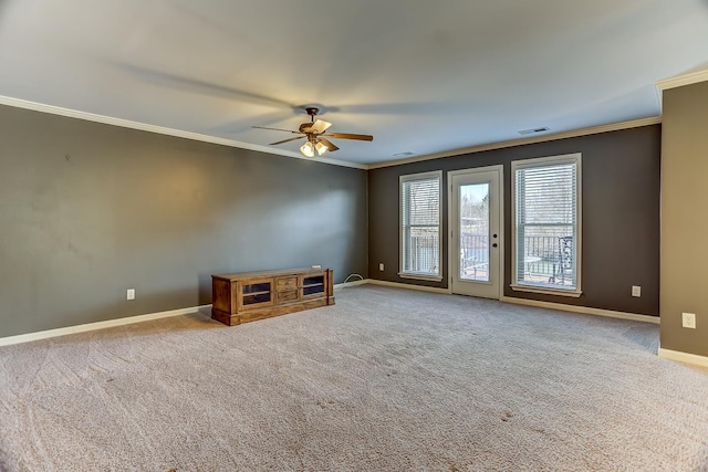 spare room featuring ceiling fan, crown molding, and carpet floors