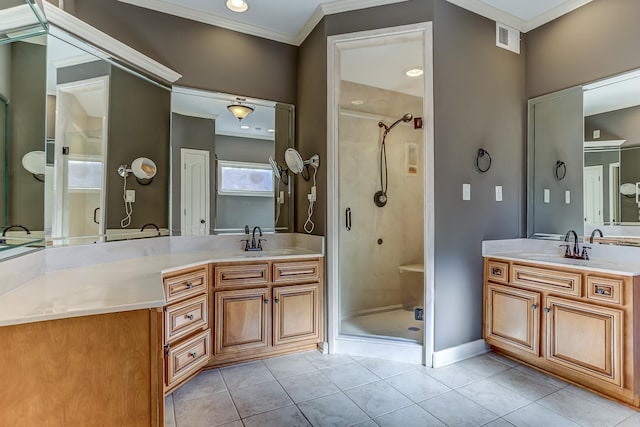 bathroom with vanity, tile patterned flooring, a shower with door, and crown molding