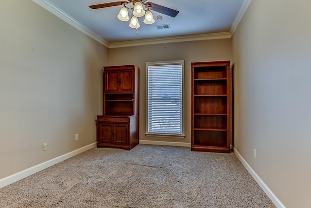 carpeted empty room featuring ceiling fan and crown molding