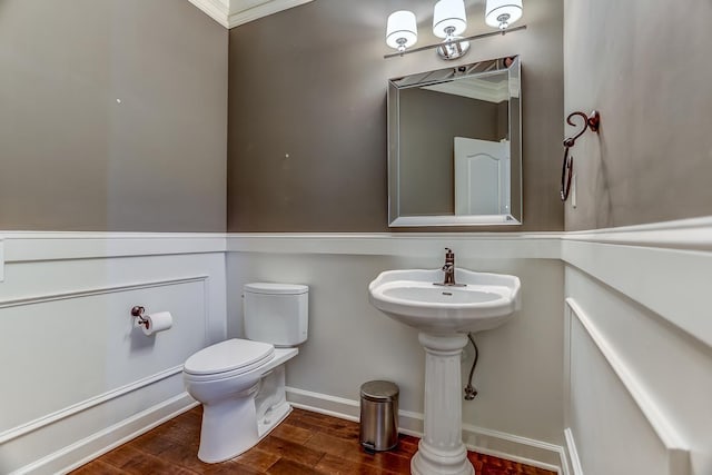 bathroom featuring toilet and ornamental molding