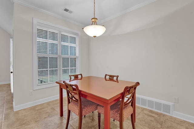 dining area with crown molding and light tile patterned flooring