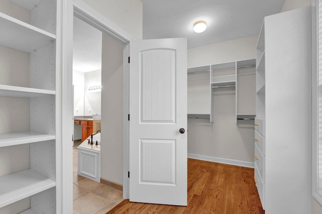 spacious closet featuring light hardwood / wood-style flooring