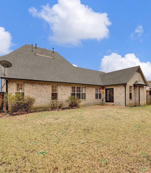 back of property featuring a lawn