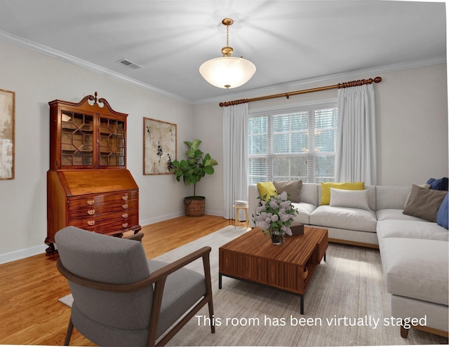 living room with light wood-type flooring and ornamental molding