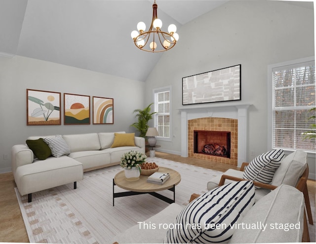 living room with a notable chandelier, a wealth of natural light, a tile fireplace, and high vaulted ceiling