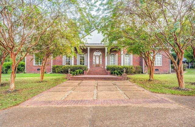 obstructed view of property with a front lawn