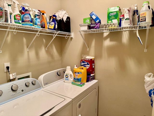 clothes washing area with washing machine and clothes dryer