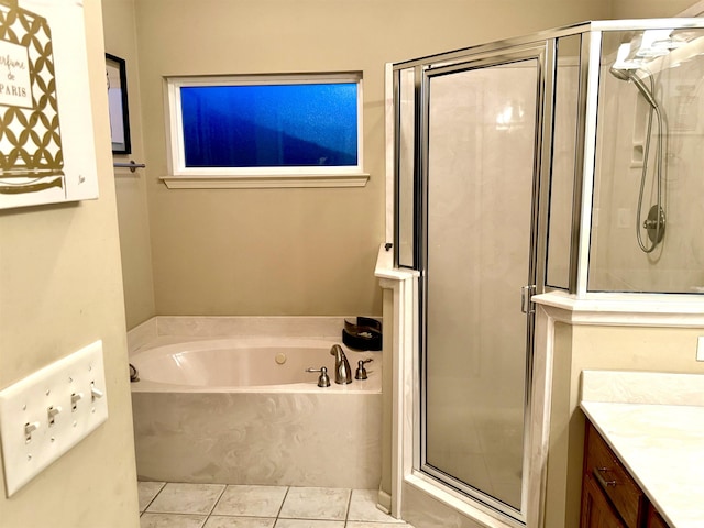 bathroom featuring tile patterned flooring, vanity, and plus walk in shower