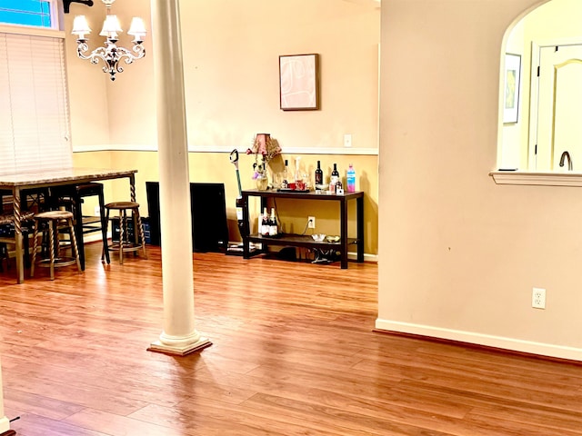 interior space with hardwood / wood-style floors and an inviting chandelier