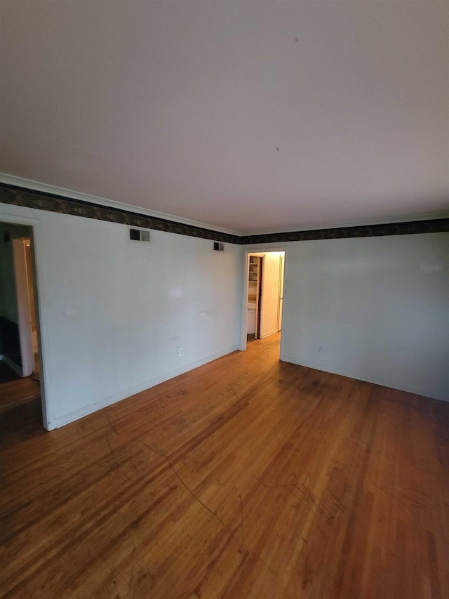 empty room featuring wood-type flooring